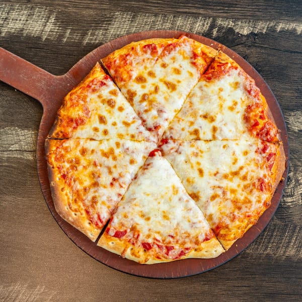 Invictus Pizza Kitchen's classic cheese pizza, cut into six slices, on a wooden pizza peel.